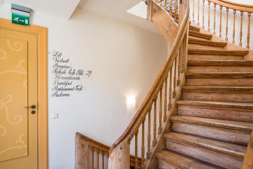 a staircase in a house with a sign on the wall at Meriton Old Town Garden Hotel in Tallinn
