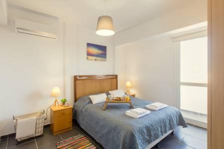 een slaapkamer met een bed met een tafel erop bij SEE VIEW COSY 3 BEDROOM FLAT in Protaras
