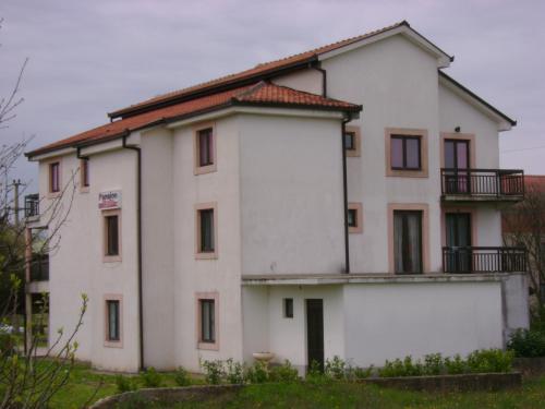 a large white building with a red roof at Guest House Robi in Međugorje