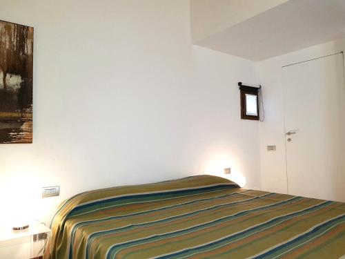 a bedroom with a bed in a white room at Villa Ottocento in Campertogno