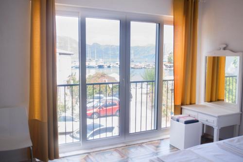 a bedroom with a large window with a view at Hydas Pension in Selimiye