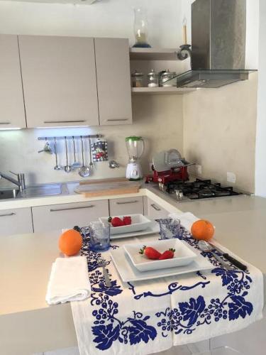a kitchen with a blue and white counter top at La casa dei tramonti in Baja Sardinia