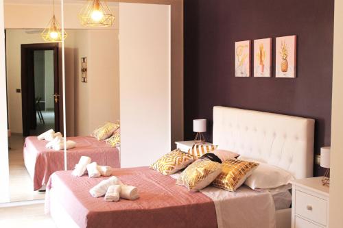 a bedroom with two beds and a mirror at Villa i Minnulareddi in Giardini Naxos