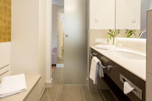 La salle de bains est pourvue d'un lavabo et d'un miroir. dans l'établissement EMICH´S Hotel, à Amorbach