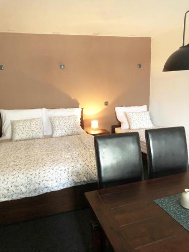a bedroom with a bed and a table and chairs at Kazmarka in Malá Morávka