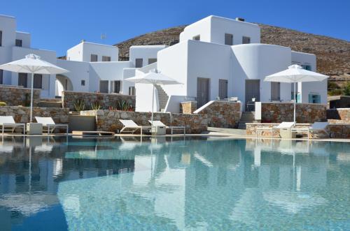 a swimming pool with white buildings in the background at Mar Inn Hotel in Chora Folegandros