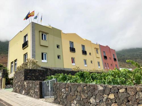 a building with two flags on top of it at Apartamentos Los Verodes in Frontera