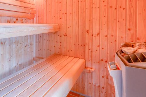 a wooden sauna with a wooden bench in it at Strandhaus Thiessow Whg_ 1 in Thiessow