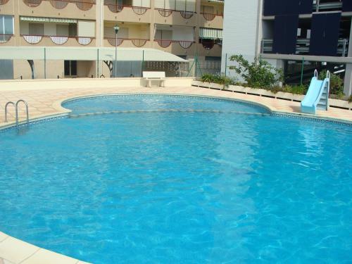 a large blue swimming pool in a building at Alpen1 La Volta in Peñíscola