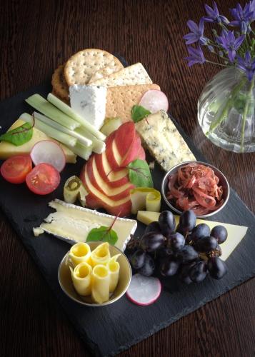 a tray of different types of cheese and fruits and vegetables at The George at Nunney in Frome