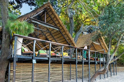 a resort with a thatched roof with a bed at Ichingo Chobe River Lodge by Mantis in Punga