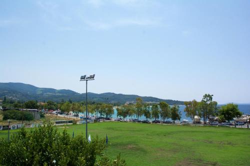 a park with a field and a street light at Thetis Boutique Apartments in Neos Marmaras
