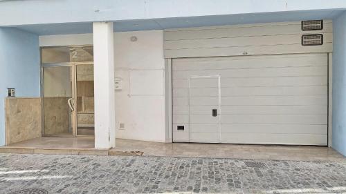 a garage with a white garage door in a room at Brisas del Guadiana in Ayamonte