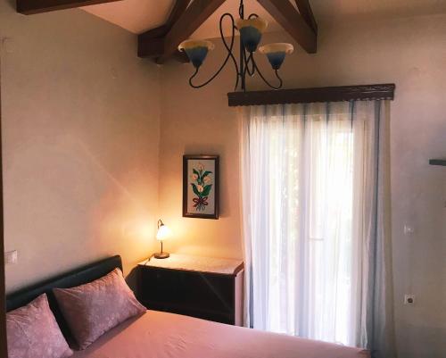 a bedroom with a bed and a window at Seaside House in Aigio