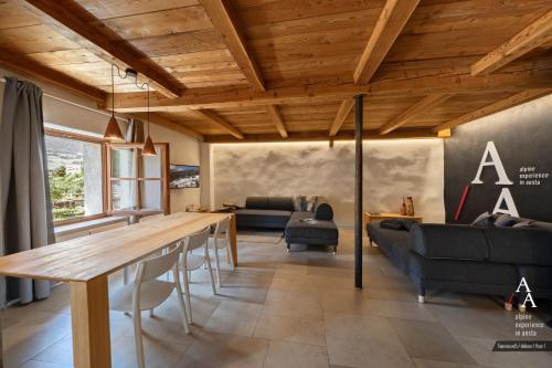 a living room with a table and a couch at Alp Apartments SKI & BIKE - Tourneuve5 in Aosta