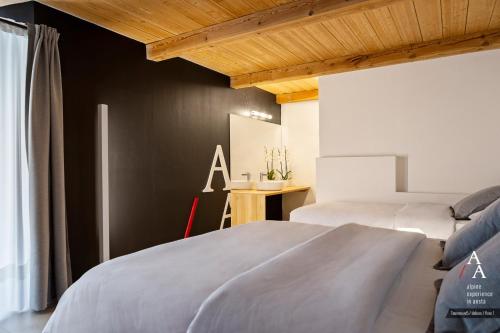 a bedroom with two beds and a table in a room at Alp Apartments SKI & BIKE - Tourneuve5 in Aosta