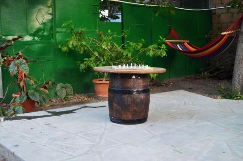 a table sitting on top of a stump in a garden at Ashtarak Garden GuestHouse in Ashtarak