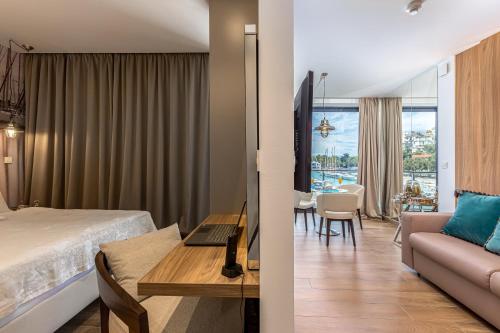 a hotel room with a bed and a living room at Apartments Marina Novi in Novi Vinodolski