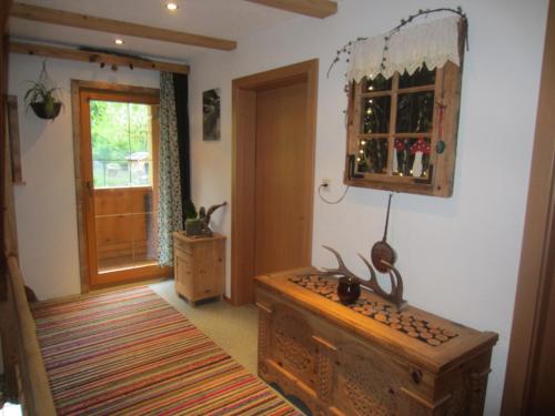 a living room with a dresser and a mirror at Ferienwohnung Spitaler Unterkofler in Hippach