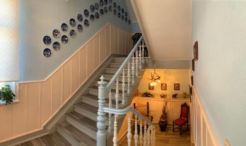 a staircase with blue and white plates on the wall at Villa Borchert in Wernigerode
