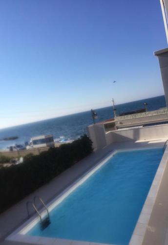 a swimming pool with a view of the ocean at Palese Profumo di Mare in Santo Spirito