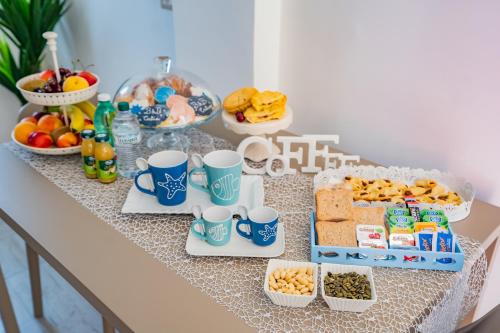 a table with a buffet of food and drinks at Bebcatia in Agropoli