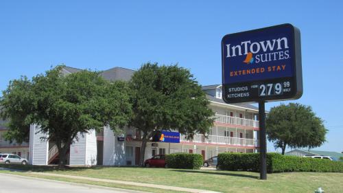 a sign for a hotel in front of a building at InTown Suites Extended Stay Lewisville TX Valley View Dr in Lewisville