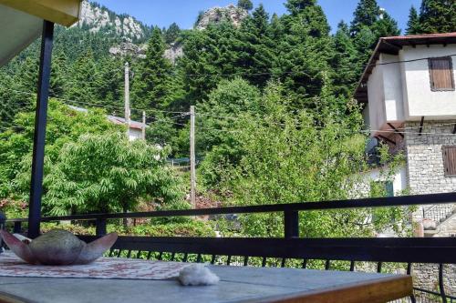 a balcony with a table with a view of a mountain at The House with the Hydrangeas in Elati Trikalon