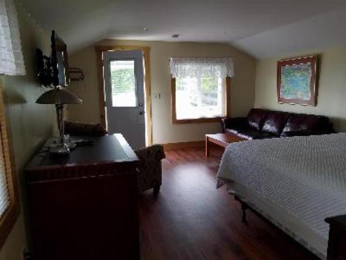 a living room with a bed and a couch at Grand View Resort in Weirs Beach