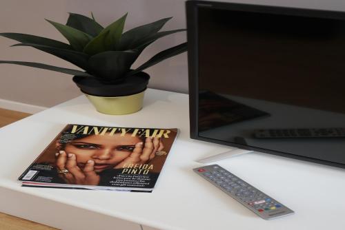 a magazine sitting on a desk next to a laptop at Welc-oM Casa Anna in Padova