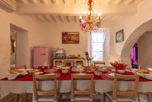 a dining room with a table with food on it at B&B Country House Poggio Del Drago in Ponticino