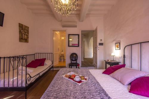 a bedroom with two beds and a tray of fruit on a table at B&B Country House Poggio Del Drago in Ponticino