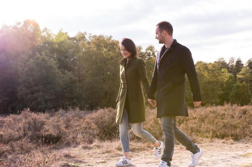 a man and a woman walking down a dirt road at Hotel de Sterrenberg - Adults Only in Otterlo