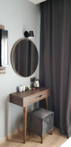 a wooden table with a mirror on top of it at Basilissis Hotel in Istanbul