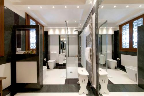 a bathroom with two toilets and a shower at Palazzetto Pisani Grand Canal in Venice