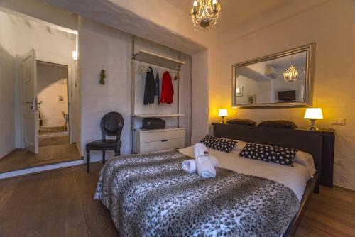 a bedroom with a bed with a teddy bear on it at B&B Country House Poggio Del Drago in Ponticino
