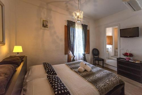 a bedroom with a bed with two pillows on it at B&B Country House Poggio Del Drago in Ponticino