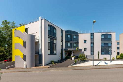 a building with a large letter f in front of it at B&B HOTEL Cholet Sud in Cholet
