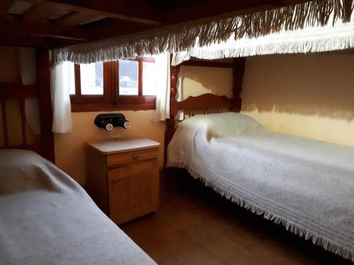 a bedroom with two beds and a window at Cabañas Inti Killa (MR) in Cachí