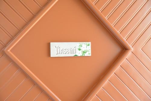 an orange ceiling with a sign that reads jasmine at Petros Giatras - Rooms in Zakynthos Town