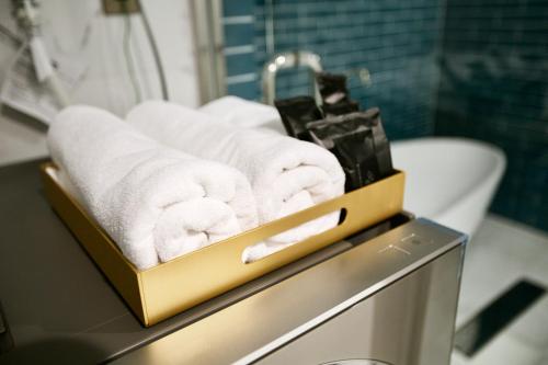 a tray of towels on a counter in a bathroom at THE ROOT2 HOTEL in Kyoto