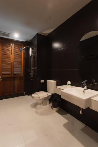 a bathroom with a white toilet and a sink at House Of Papa Bangkok Siam in Bangkok