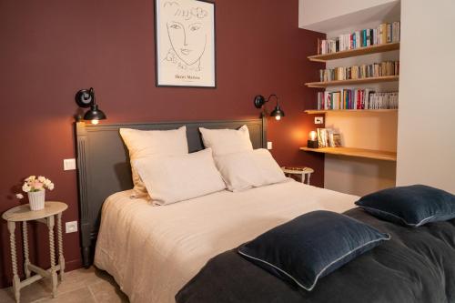 a bedroom with a bed and a book shelf at Le Clos d'Abrigeon in Aubenas