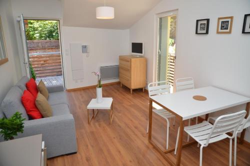 a living room with a couch and a table at Le Clos des Salins in Toulouse