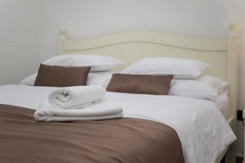 a bedroom with two beds with white towels on them at Casa Nuova in Kotor