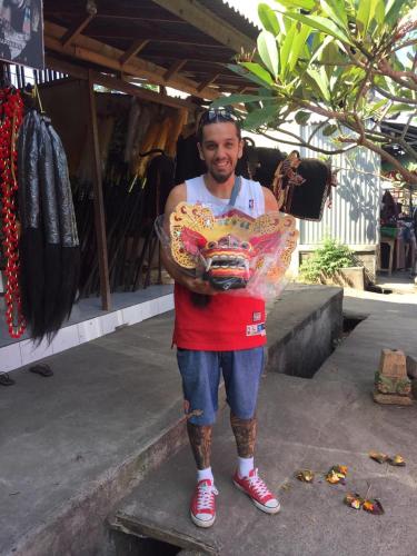 a man standing on a step holding a bowl at Pondok Serayu in Ubud