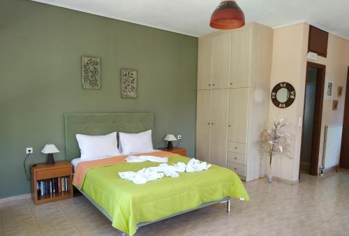 a bedroom with a bed with towels on it at Gaea Gardens Studios & Villas in Petra