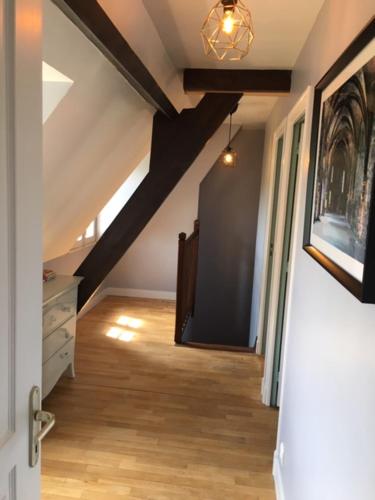 an attic room with a hallway with a ceiling at Gite de la petite masse in Amboise