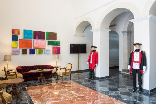 two mannequins in a living room with paintings on the wall at Vila Gale Collection Elvas in Elvas
