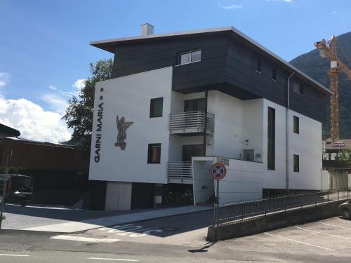 a black and white building with a sign on it at Garni Maria in Varna
